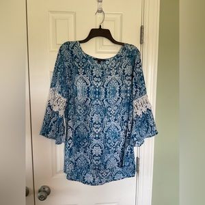 Three quarter, detailed bell sleeve blouse.